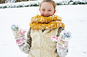 Smiling girl playing in snow