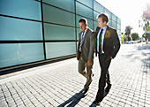 Businessmen walking on city street