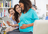 Pregnant woman using tablet computer