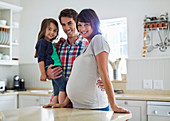 Family smiling together in kitchen