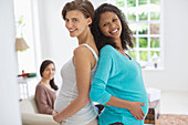 Pregnant women smiling together