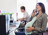 Pregnant businesswoman on telephone