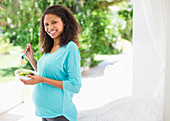 Pregnant woman eating salad