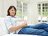 Pregnant woman relaxing on sofa