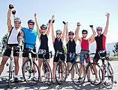 Cyclists cheering together on rural road