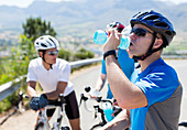 Cyclist drinking water on rural road