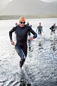 Triathletes emerging from water