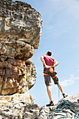 Climber examining rock formation