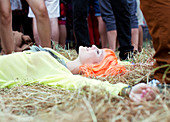 Woman in wig laying in grass