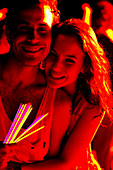 Happy couple with glow sticks