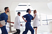 Hospital staff running down hallway
