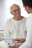 Doctor talking with older patient room