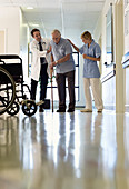 Doctor and nurse helping patient walk
