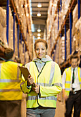Worker holding clipboard in warehouse