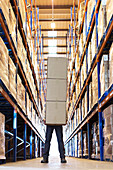 Worker holding boxes in warehouse