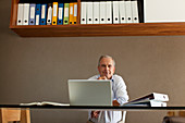 Older man sitting at desk