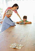 Three generations of women counting money