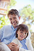 Father and daughter hugging outdoors