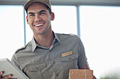 Delivery boy smiling with package