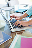 Businesswoman using laptop at desk