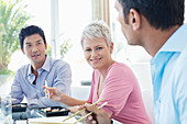 Business people eating sushi in office