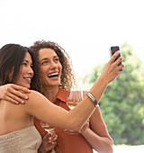 Friends taking pictures together outdoors