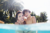 Mother holding son in swimming pool