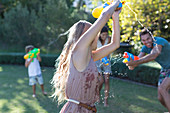 Family playing with water guns