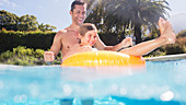 Father and son playing in swimming pool