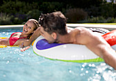 Couple relaxing in swimming pool