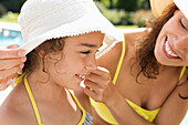 Mother and daughter wearing sunhats