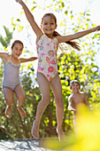 Children jumping on trampoline outdoors