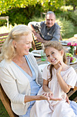 Older woman sitting with granddaughter