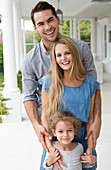 Family smiling together on porch