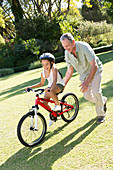 Older man, granddaughter and bicycle