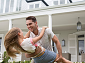 Couple playing outside house