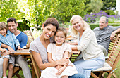 Family smiling at table outdoors