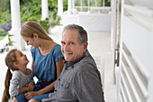 Older man smiling on porch