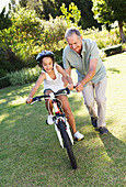 Older man, granddaughter and bicycle