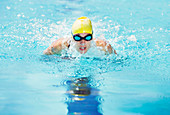 Swimmer wearing goggles in pool