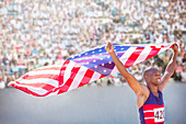Track and field athlete holding flag