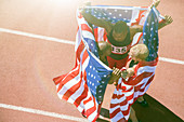 Track and field athletes holding flags