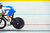 Track cyclist riding in velodrome