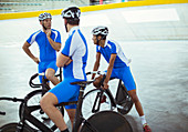 Track cycling team talking in velodrome