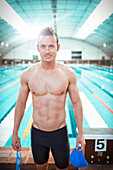 Swimmer standing at poolside