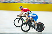 Track cyclists racing in velodrome
