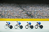 Track cycling team riding in velodrome