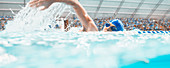 Swimmer racing in pool