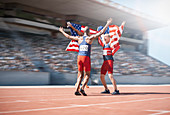 Runners celebrating and holding flags