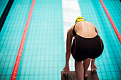 Swimmer poised at starting block